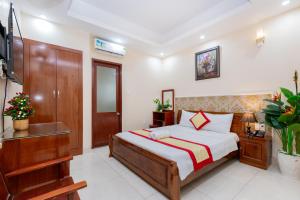 Postel nebo postele na pokoji v ubytování Biển Vàng Vũng Tàu Hotel