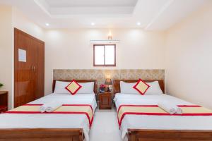 Postel nebo postele na pokoji v ubytování Biển Vàng Vũng Tàu Hotel