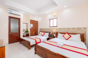 Postel nebo postele na pokoji v ubytování Biển Vàng Vũng Tàu Hotel