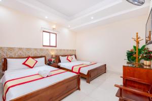Postel nebo postele na pokoji v ubytování Biển Vàng Vũng Tàu Hotel