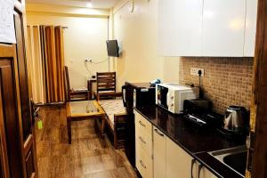a kitchen with a counter top with a microwave at Vista Casita Ranikhet Serene Homestay Himalaya Lap in Rānīkhet