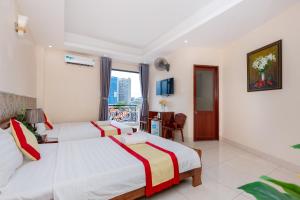 Postel nebo postele na pokoji v ubytování Biển Vàng Vũng Tàu Hotel