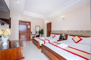 Postel nebo postele na pokoji v ubytování Biển Vàng Vũng Tàu Hotel
