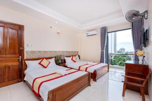 Postel nebo postele na pokoji v ubytování Biển Vàng Vũng Tàu Hotel