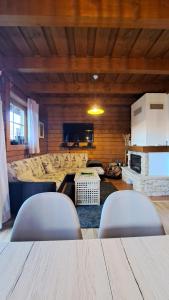a living room with two chairs and a table at Chata Alexandra in Terchová +18 photos
