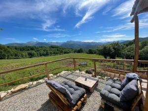 a patio with two chairs and a table and mountains at Cozy Tiny House plus SPA - à Pereille d'en Haut in Péreille