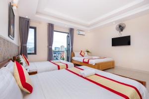 Postel nebo postele na pokoji v ubytování Biển Vàng Vũng Tàu Hotel