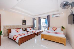 Postel nebo postele na pokoji v ubytování Biển Vàng Vũng Tàu Hotel + 37 fotografií