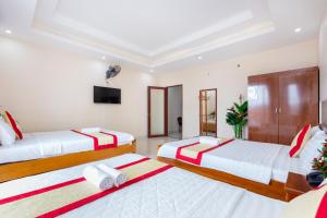 Postel nebo postele na pokoji v ubytování Biển Vàng Vũng Tàu Hotel