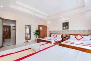 Postel nebo postele na pokoji v ubytování Biển Vàng Vũng Tàu Hotel