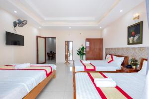 Postel nebo postele na pokoji v ubytování Biển Vàng Vũng Tàu Hotel