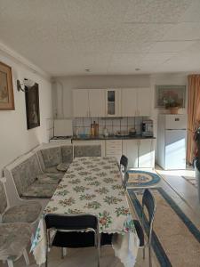 a living room with a table and a kitchen at Britania in Bran +19 photos