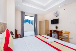 Postel nebo postele na pokoji v ubytování Biển Vàng Vũng Tàu Hotel