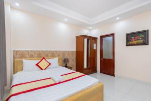 Postel nebo postele na pokoji v ubytování Biển Vàng Vũng Tàu Hotel