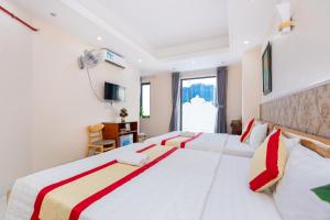 Postel nebo postele na pokoji v ubytování Biển Vàng Vũng Tàu Hotel