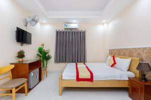Postel nebo postele na pokoji v ubytování Biển Vàng Vũng Tàu Hotel