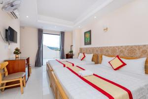 Postel nebo postele na pokoji v ubytování Biển Vàng Vũng Tàu Hotel