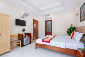 Postel nebo postele na pokoji v ubytování Biển Vàng Vũng Tàu Hotel