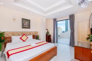 Postel nebo postele na pokoji v ubytování Biển Vàng Vũng Tàu Hotel