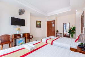 Postel nebo postele na pokoji v ubytování Biển Vàng Vũng Tàu Hotel