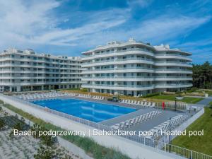 a large apartment building with a swimming pool at Rogowo Pearl Apartamenty in Rogowo