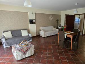 a living room with a couch and a table at Casa La Ferula apt1 vicino al mare e Taormina in SantʼAlessio Siculo
