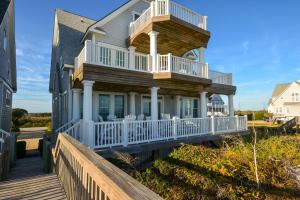 a house with a wrap around porch and a deck at My Blue Haven in North Topsail Beach
