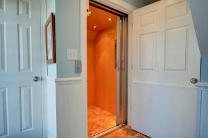 a hallway with a white door and an orange wall at My Blue Haven in North Topsail Beach