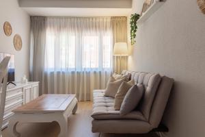 a living room with a couch and a table at AH Apartamento Urban Lena VUT6048AS in Pola de Lena