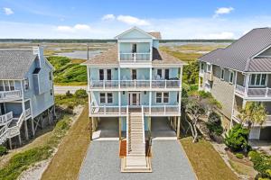 an aerial view of a blue house with a balcony at Ocean Sounds in West Onslow Beach