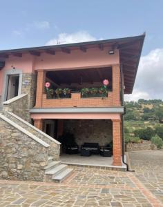 a house with a balcony with pink flowers on it at Tenuta il Giardino di Eros in Albanella