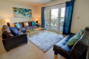 a living room with a couch and a table at Villa Capriani 109B in North Topsail Beach