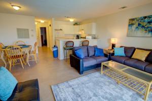 a living room with a couch and a table at Villa Capriani 109B in North Topsail Beach