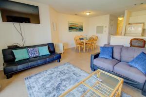 a living room with two couches and a table at Villa Capriani 109B in North Topsail Beach