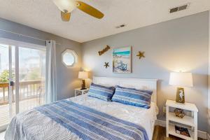 a bedroom with a bed and a balcony at Bermuda Place in North Topsail Beach +24 photos