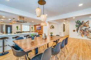 a dining room and kitchen with a wooden table and chairs at Fox Garden-heated Pool-spa- Boho-downtown & Beach in Fort Lauderdale