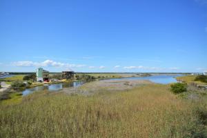 a view of a river with a building in the distance at Knot Fade Away in North Topsail Beach