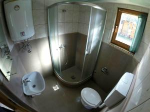 a bathroom with a shower and a toilet and a sink at Rafting Camp Modra Rijeka in Šćepan-Polje +53 photos