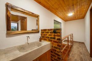 a bathroom with a sink and a mirror at La Tribuna de los Andes Cabin 2 in Arcabuco +35 photos