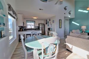 a kitchen and living room with a table and chairs at On Slow Time in West Onslow Beach