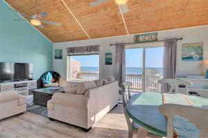 a living room with a couch and a table at On Slow Time in West Onslow Beach +17 photos