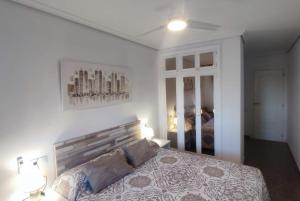 a bedroom with a large bed and a mirror at Casa Emma Vinaròs in Vinarós