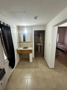 a bathroom with a counter and a sink in a room at Refugio Andino 2 in Malargüe +2 photos