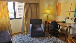 a hotel room with a desk and a chair and a desk and a chair at Hotel Live Lodge V Mariana pq Ibirapuera UH813 in Sao Paulo