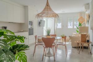 Una cocina y una sala de estar con mesa y sillas. en Alma Suite Duplex, en Caleta de Sebo