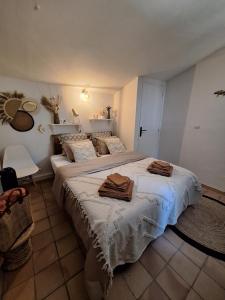 a bedroom with a large bed with towels on it at Villa Sisyphe chambre"la jeanette" in Le Thoronet +48 photos