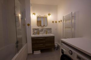 a bathroom with a tub and a sink and a shower at Aurelia - Cosy & Chic - 10min Disney - by Cosynousvoici in Chessy +26 photos