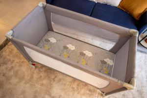 a box with sheep on it next to a couch at Appartement cosy aux portes de Disney in Chessy +24 photos