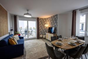 a living room with a blue couch and a table at Aurelia - Cosy & Chic - 10min Disney - by Cosynousvoici in Chessy