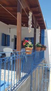 a balcony with potted plants on a house at Kalotina's House in Telendos +6 photos